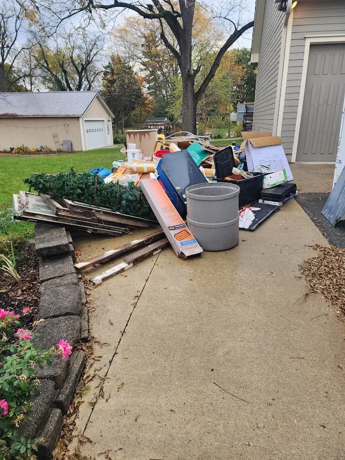 Dumpster being loaded with debris for Estate Cleanout Dumpster Rental in Kenedy